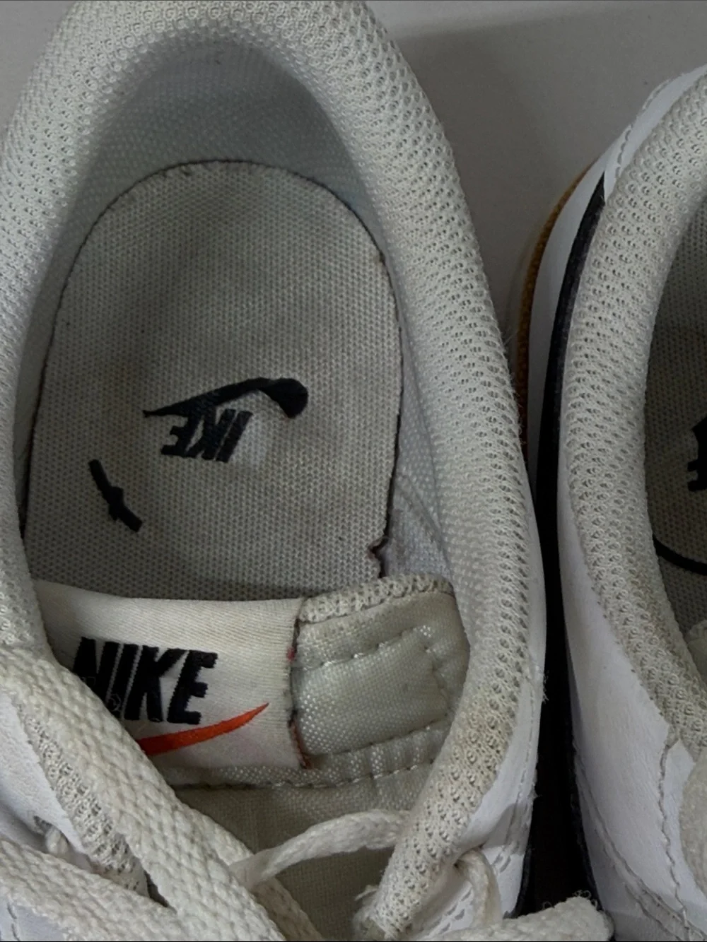 Nike White Low-Top Sneakers with Black Swoosh and Brown Trim